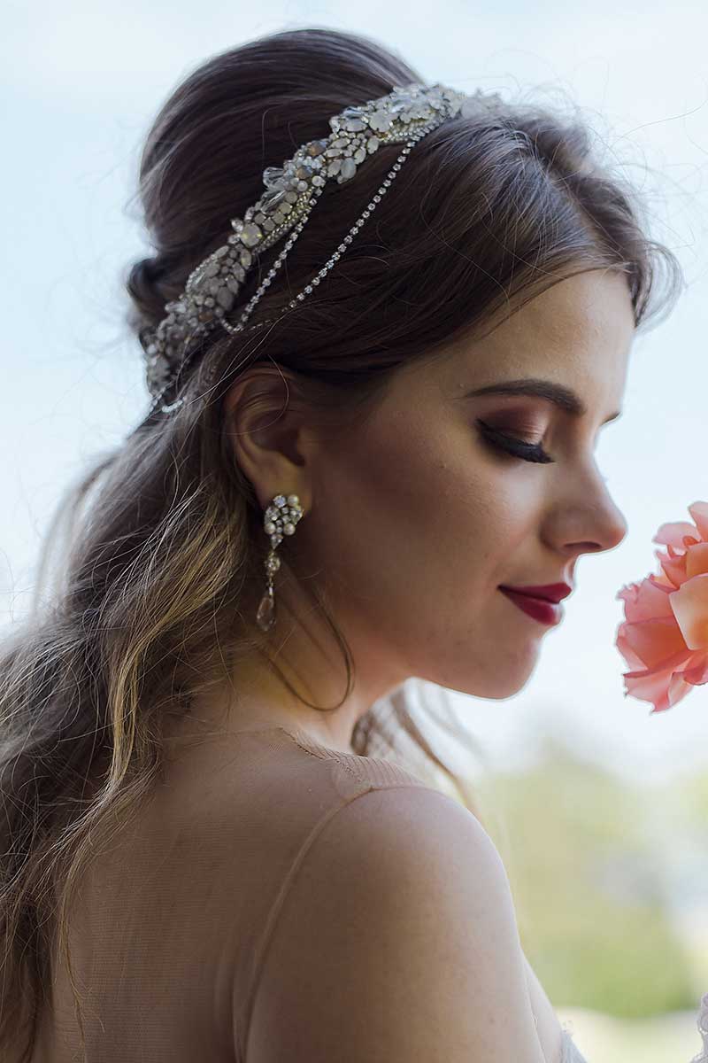 Profile of bride wearing draped halo headpiece