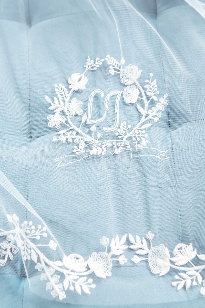 Bridal veil with monogram on a blue coach 