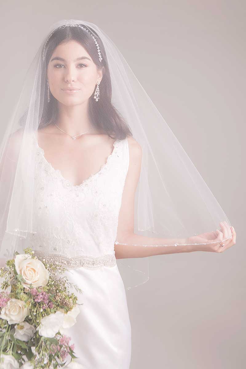 Classic, modern bride wearing Laurel marquis crystal wedding headband under Leanna chapel length blusher veil by Laura Jayne. 