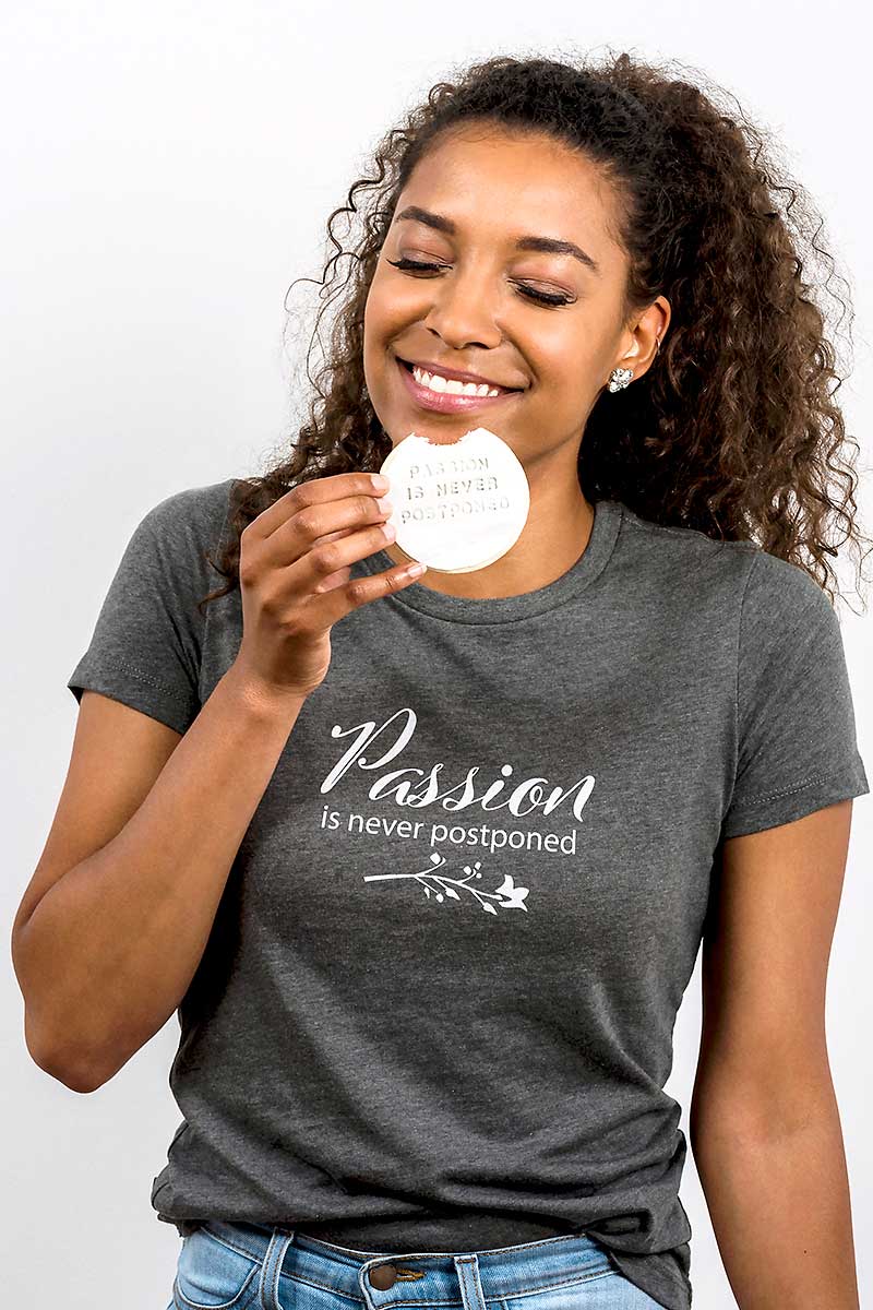 smiling curly girl eating a tee cookie 