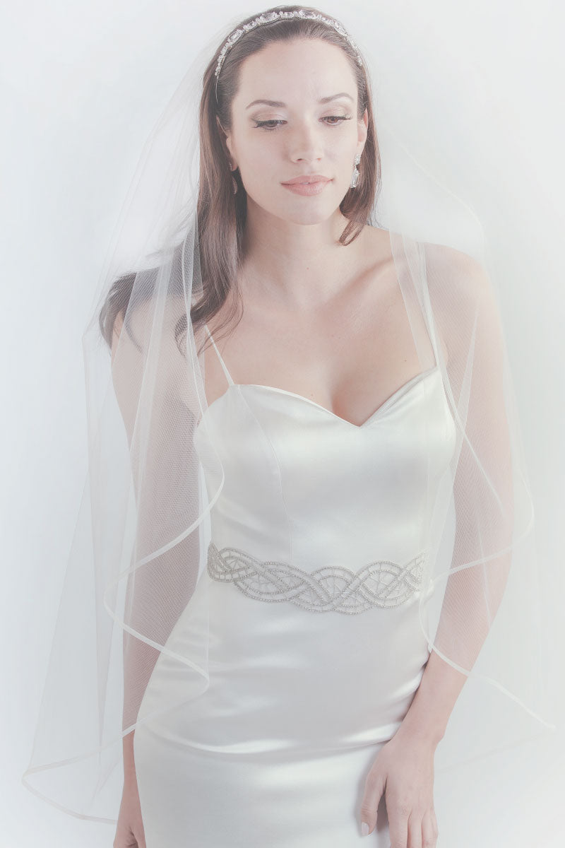 Modern minimalist bride wearing the Moderne Crystal Sash, a hand-beaded design with undulating curves, from Laura Jayne
