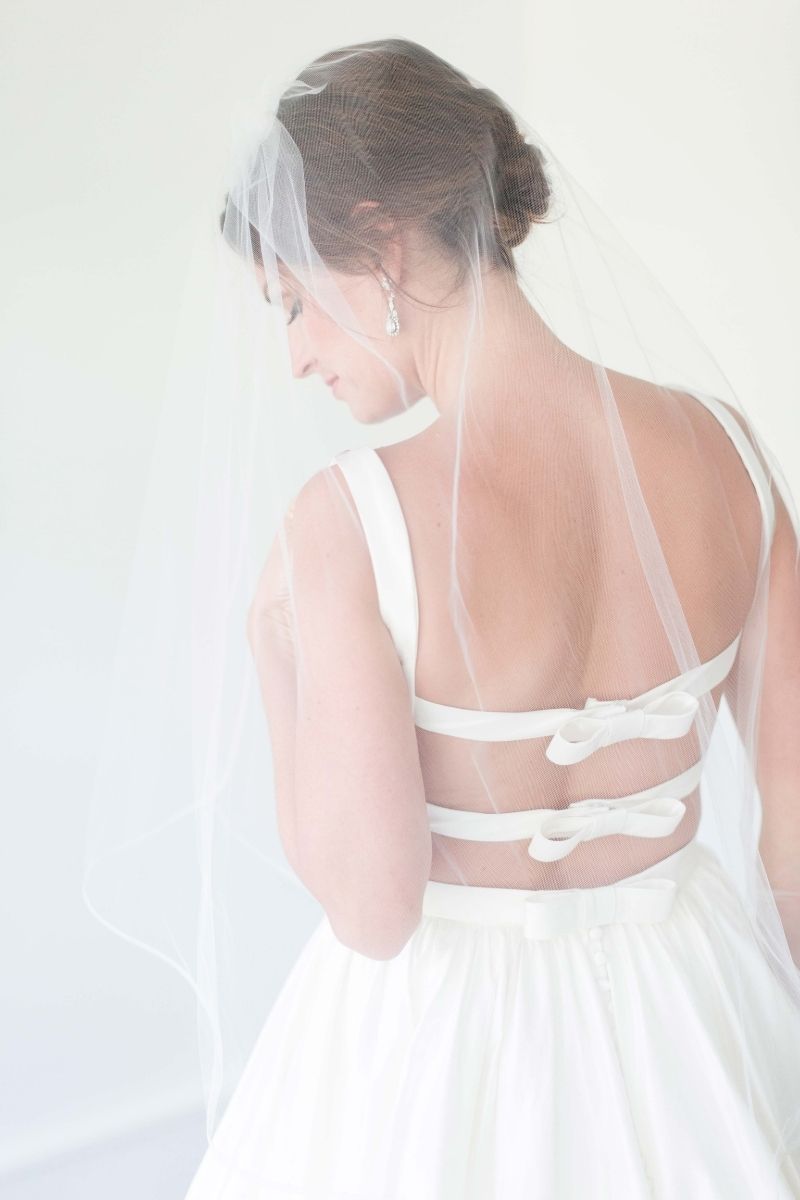 smiling bride standing in a backless dress 