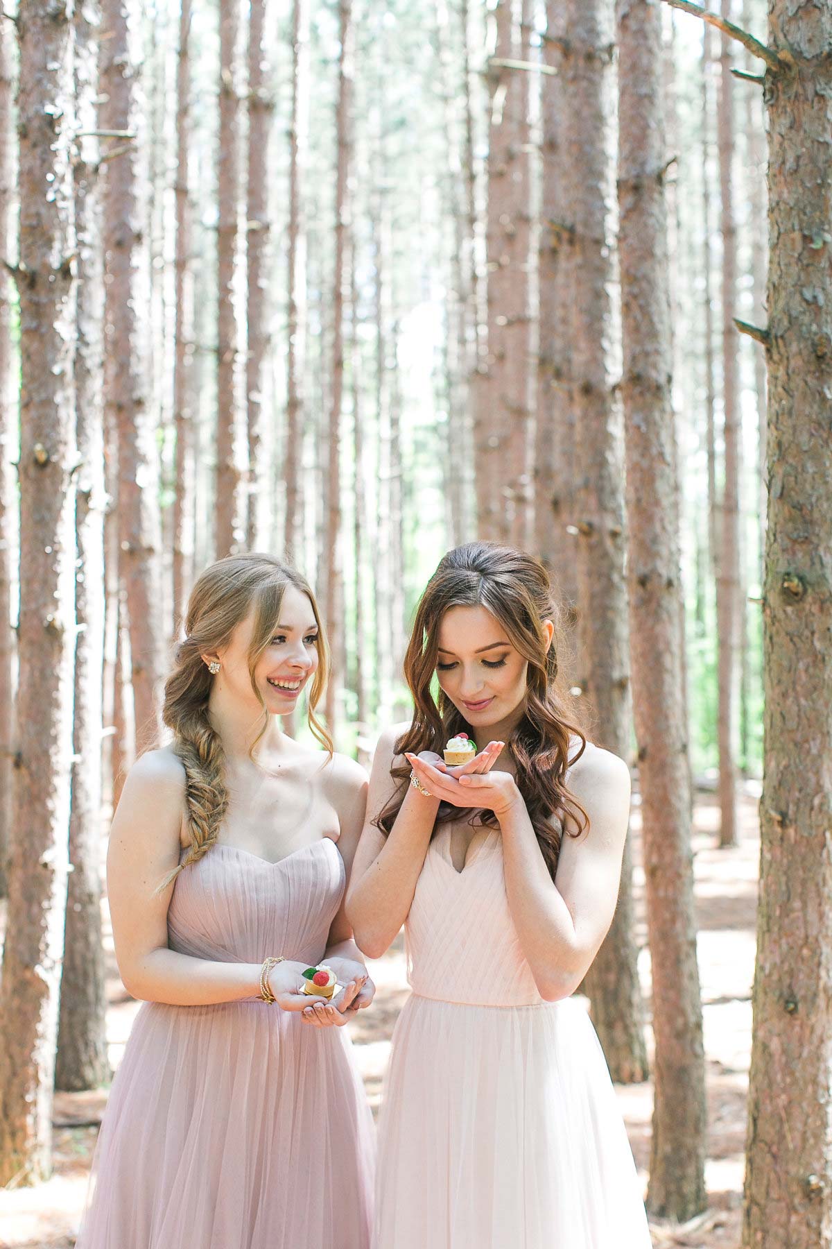 two brides maids smiling in the woods 