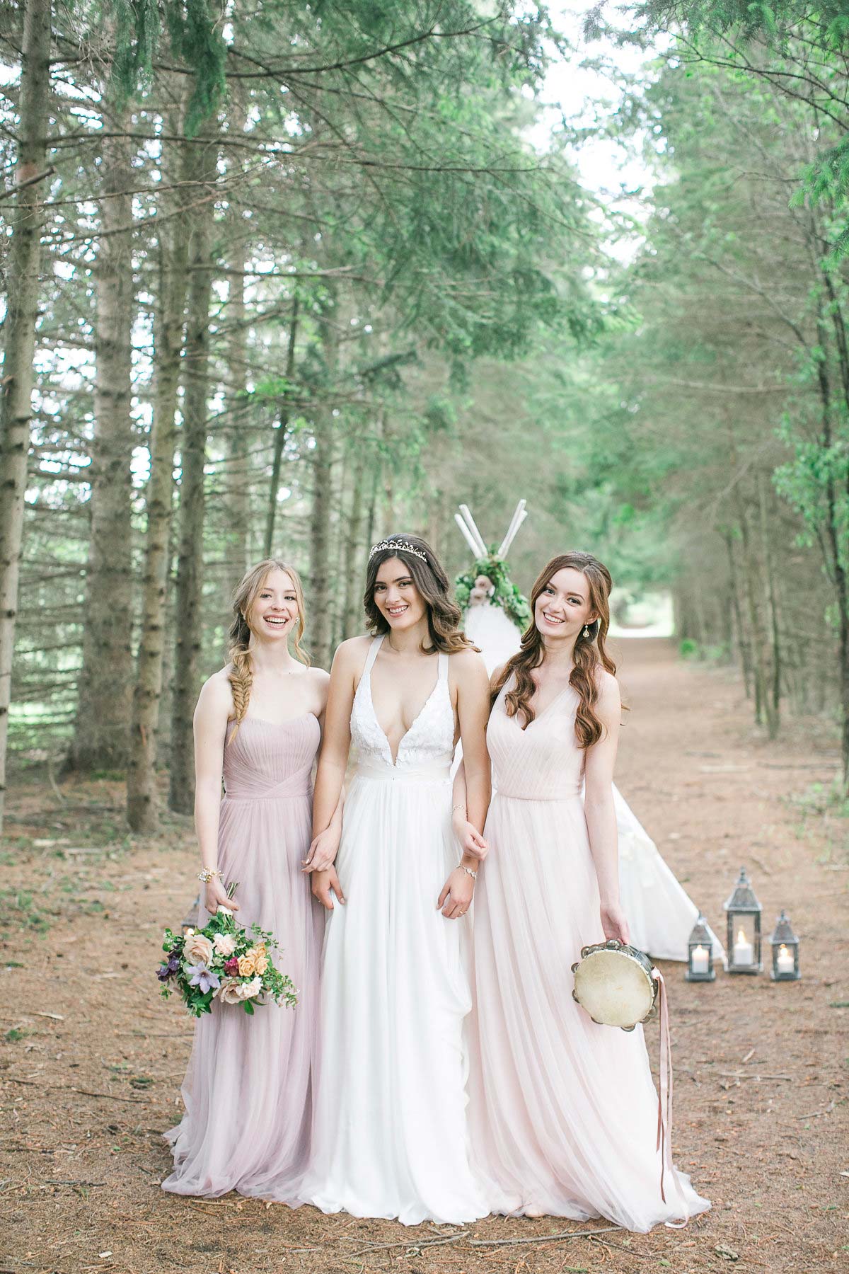 three happy bridesmaids walking in the woods 