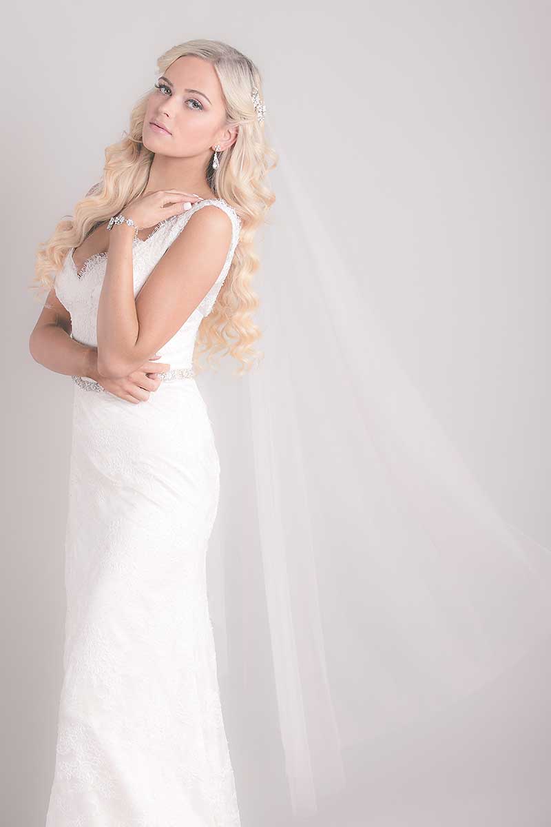 blonde girl wearing Mirage tulle drop veil Maya by Laura Jayne