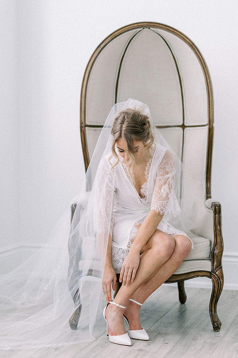 bride in veil and shoes getting ready