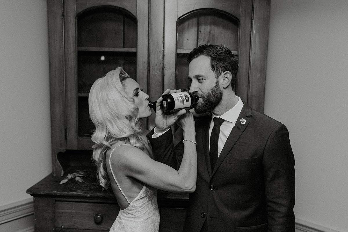 bride and groom enjoying drinks together 
