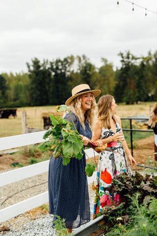 pretty lady picks beets in garden