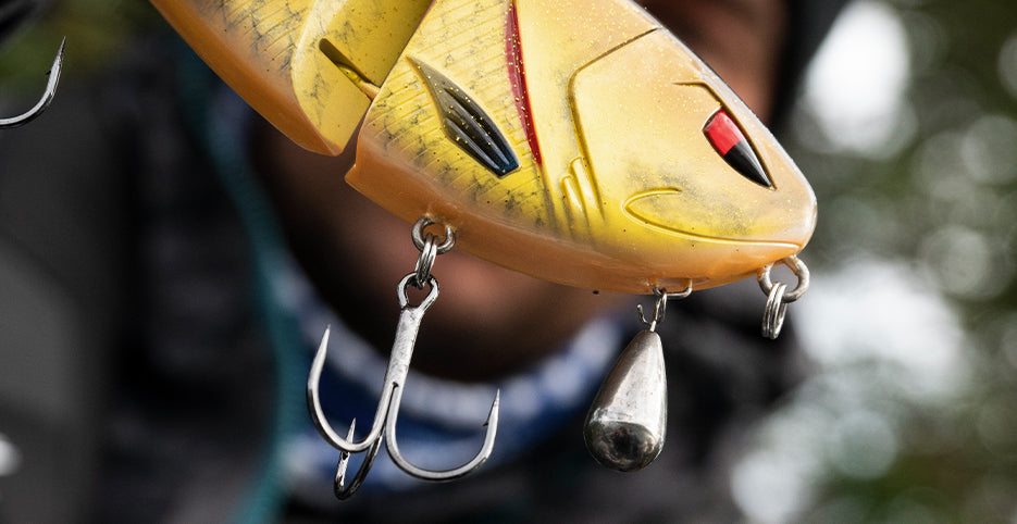 Angler on boat deck wearing Abu Garcia hat