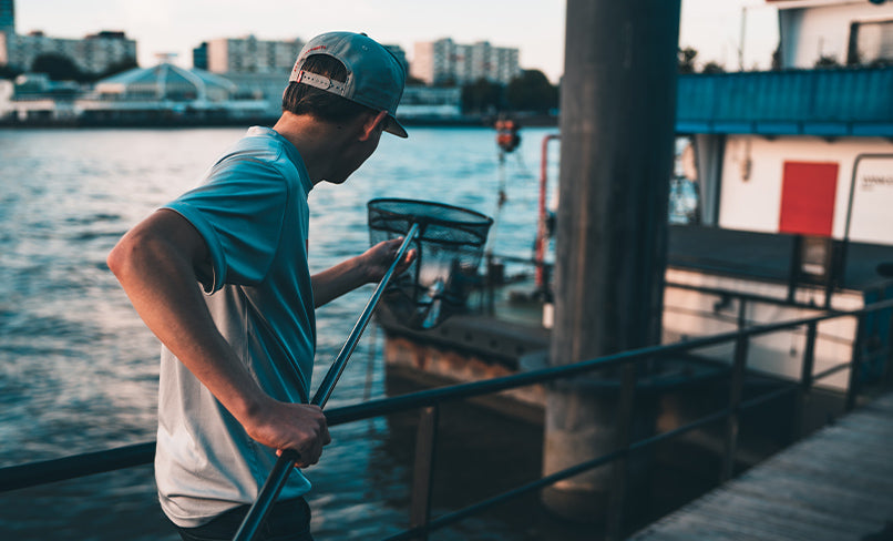 Angler holding fish with bait in mouth