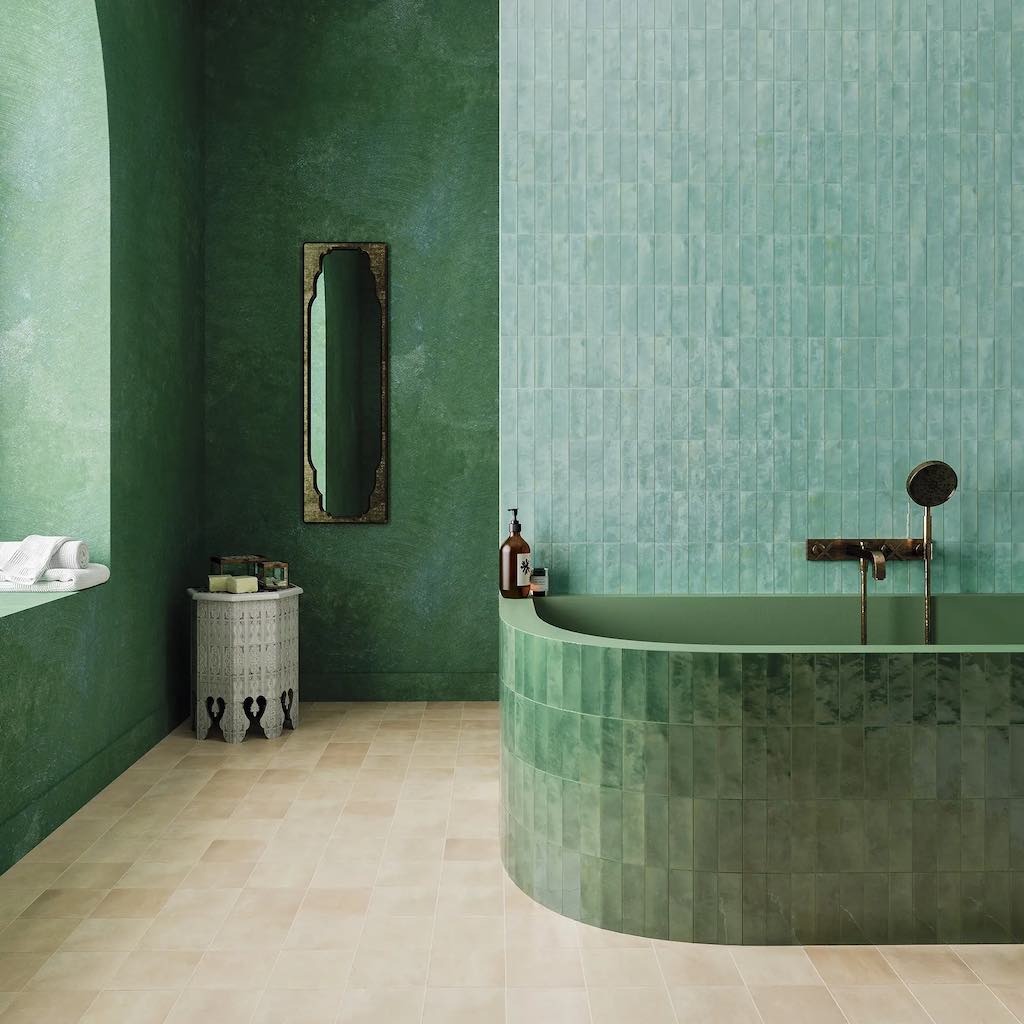 A Moroccan Style Bathroom With Terracotta Floor Tiles and Green Zellige Wall Tiles