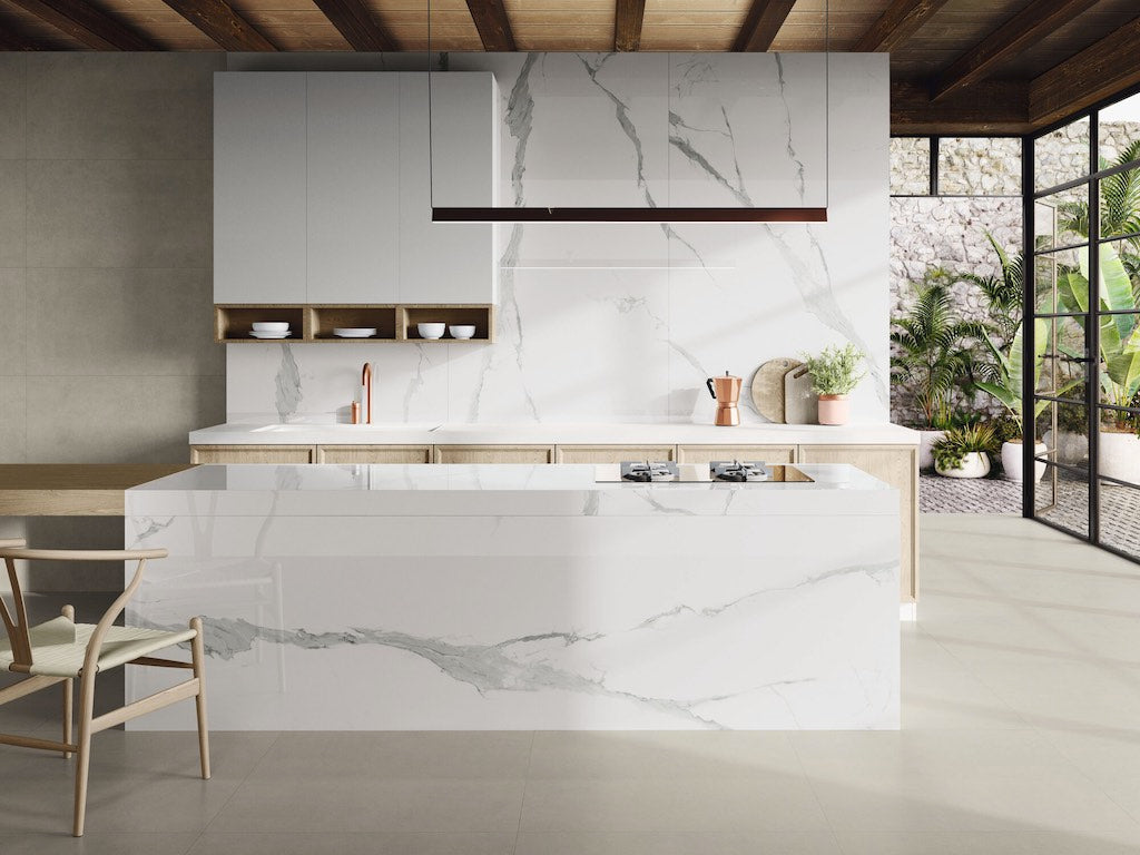 White marble kitchen island and slab backsplash