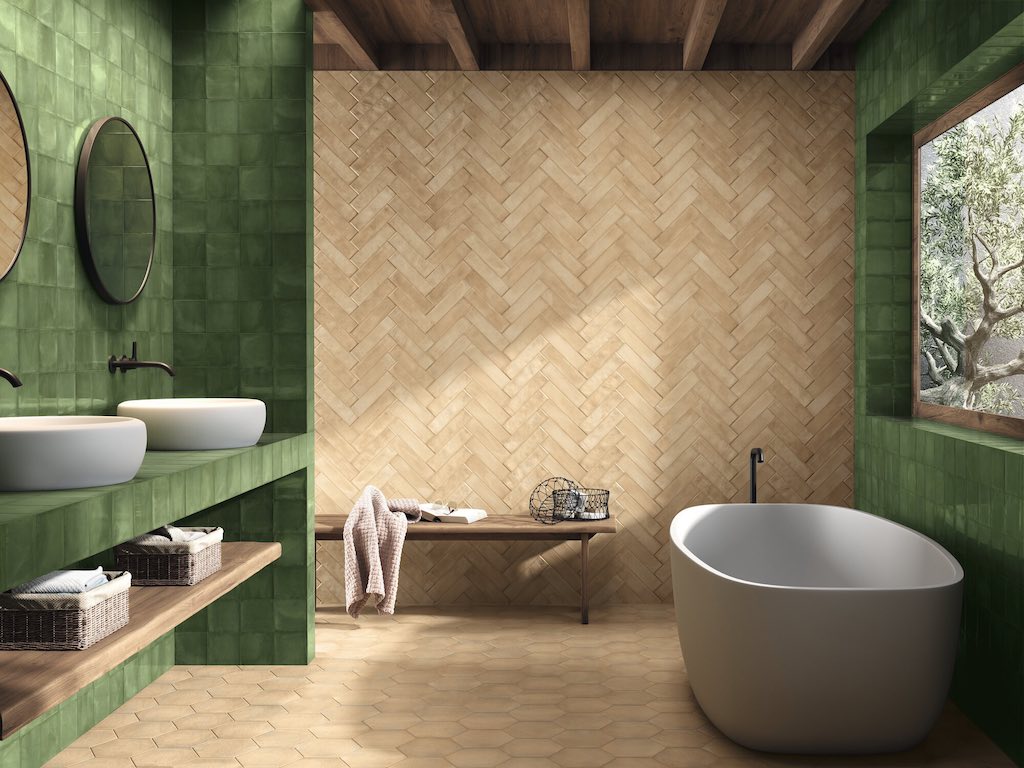 Green tiles and terracotta herringbone tiles in bathroom