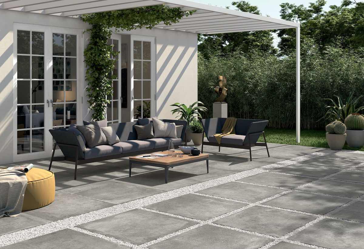 Grey outdoor porcelain tiles with contemporary garden furniture