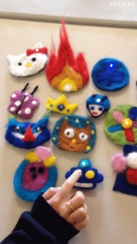 a video of a group of colorful light up badges made by scout leaders, hello kitty, a flame with an eyeball a dragon and more
