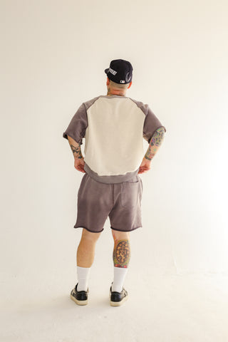 Back of oatmeal and charcoal gray Hambria cut-off sweatshirt and shorts