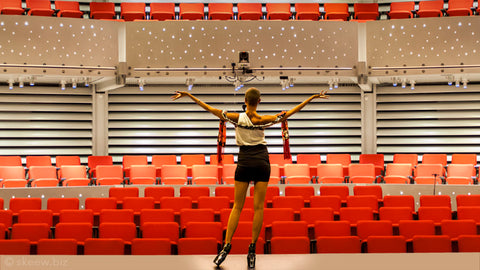Woman standing in front of an empty auditorium