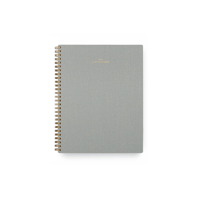 A gray 2023 planner with a gold spiral binding. 