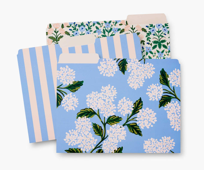 Three different file folders all in shades and patterns of blue and cream. 