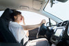 Woman yawning while driving