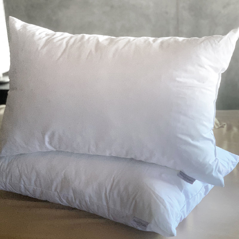 A pair of unpackaged Home Polyester Pillow on top of each other