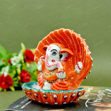 Enamelled Metal Ganesha Idol Seated in A Sea Shell - Orange
