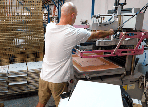 Image showing Pete making final adjustments to the ATMA automatic screen printer