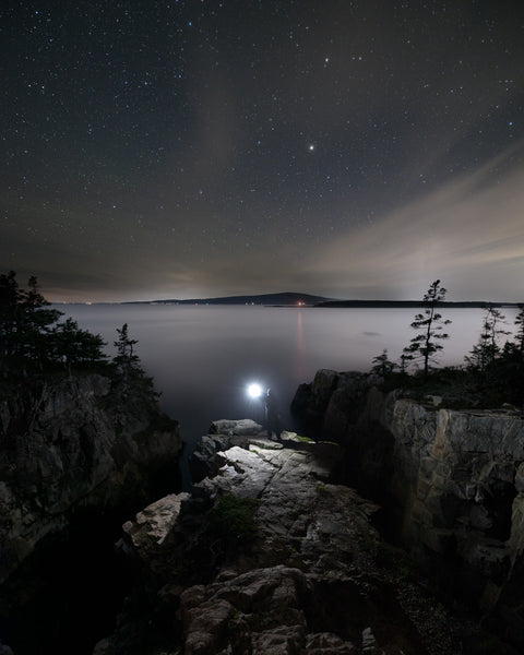 Stars shine in the night sky over the Raven's Nest, in Acadia National Park