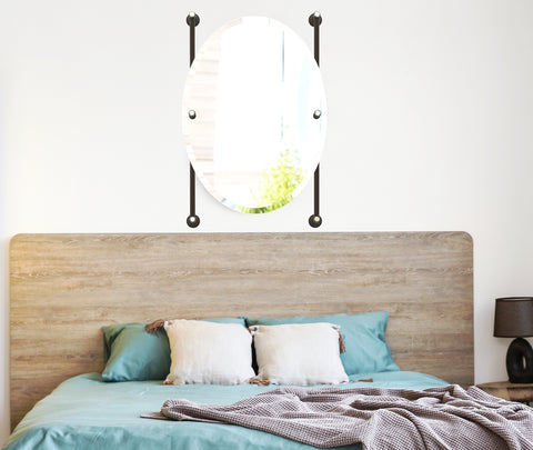 Rail mounted oval mirror over bed