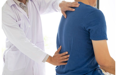 Doctor examining patient's low back