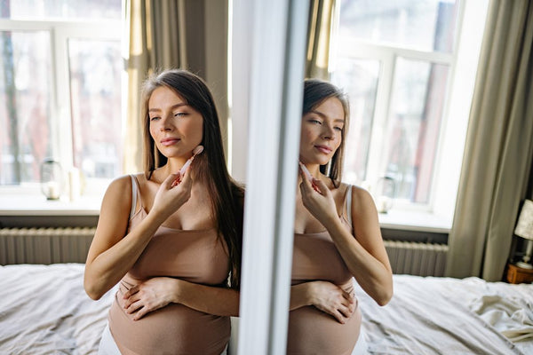 a woman uses gua sha tool with trixsent essential oils made by athena klee in vancouver canada that are organic and crueltyfree