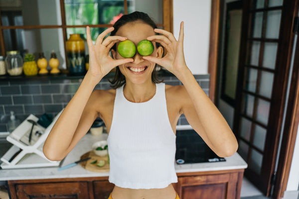 woman eating cucumber slices to add vitamins to her diet and improve skin as advised by athena klee of trixent beauty in vancouver bc