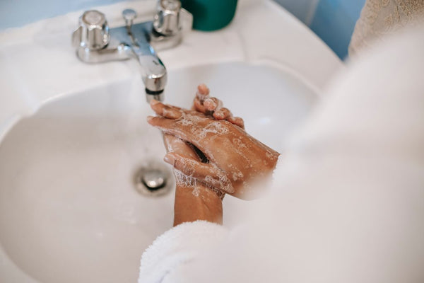 woman washes hands in winter time to prevent chapping and then uses trixsent therapy oils for heal created by athena klee