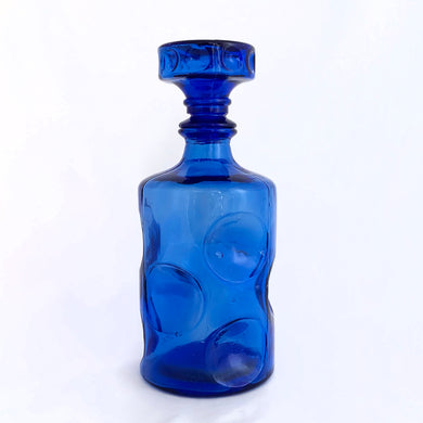Fantastic cobalt blue liquor decanter with bubble design and stopper. Made in Taiwan, circa 1970.  In good vintage condition, no chips or cracks, small manufacturer's defect on the decanter's side from a burst air bubble.  Measures 8