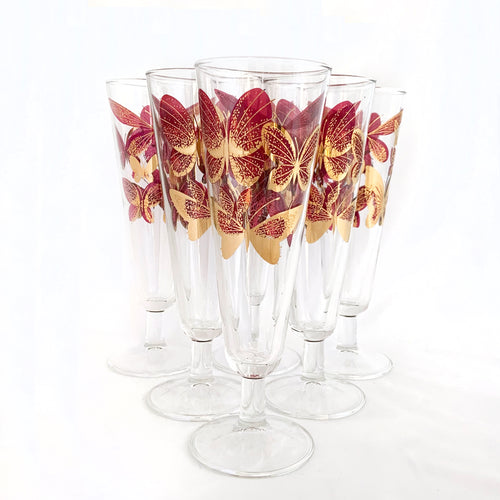 https://cdn.shopify.com/s/files/1/0518/8321/2975/products/DarkPinkandGoldButterflyPattern10ozFootedPilsnerChampagneCocktailGlassesVintageMid-CenturyRetroToronto3_250x250@2x.jpg?v=1666904827