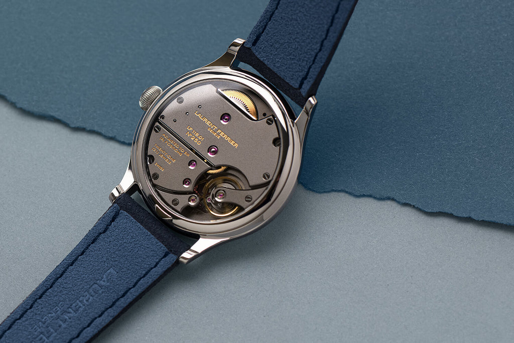 Laurent Ferrier award-winning fine watchmaker's Classic Origin model resting on a two-tone blue teared paper background showing it's highly refined 116.01 calibre. Photographer Cyril Biselx shot in Geneva, retouched in Lausanne, Switzerland