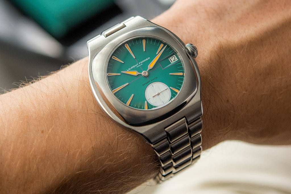 White man wearing the latest online exclusive LAURENT FERRIER Sport Auto 40 on his wrist. The watch has a beautiful green blue dial and features the number "40" on the second hand area.