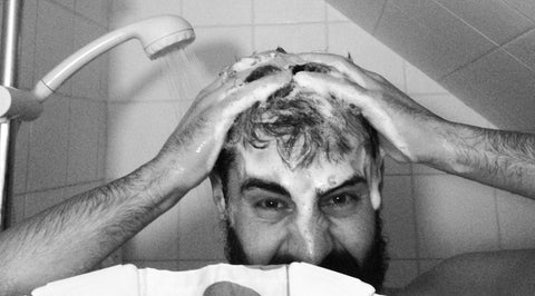 Head only shot of man washing his hair in the shower