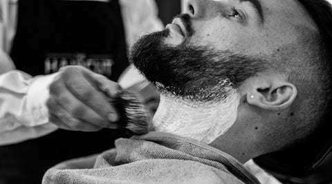 Man in barbers having beard trimmed