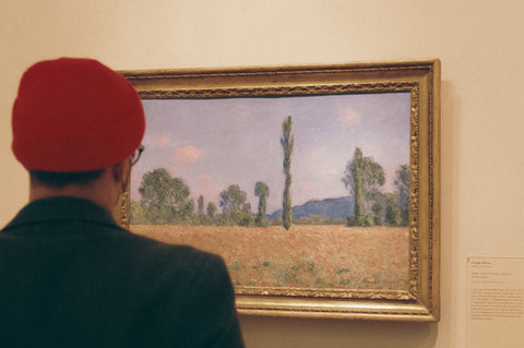 Man wearing red hat admiring painting at The Art Institute Of Chicago 