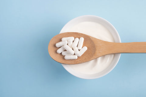 Capsules probiotic on a wooden spoon