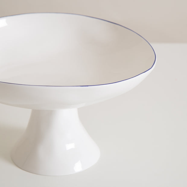 white ceramic pedestal fruit bowl