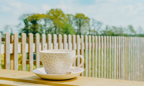 A cup of coffee outside in the sun 