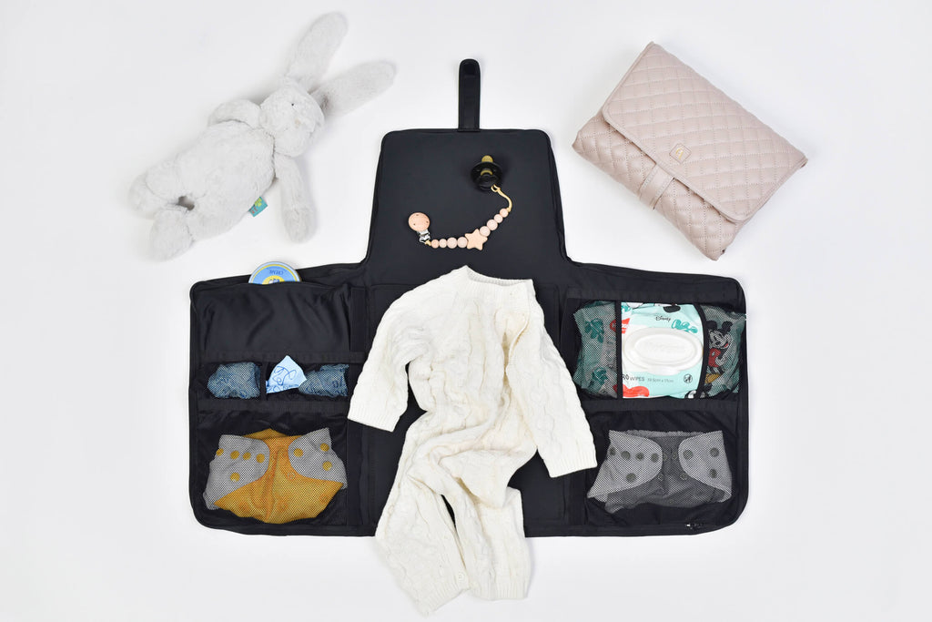 Coco Alexander Diaper bag open showing all pockets full with baby changing items