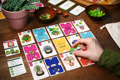 board game cards with plant theme set up on a table