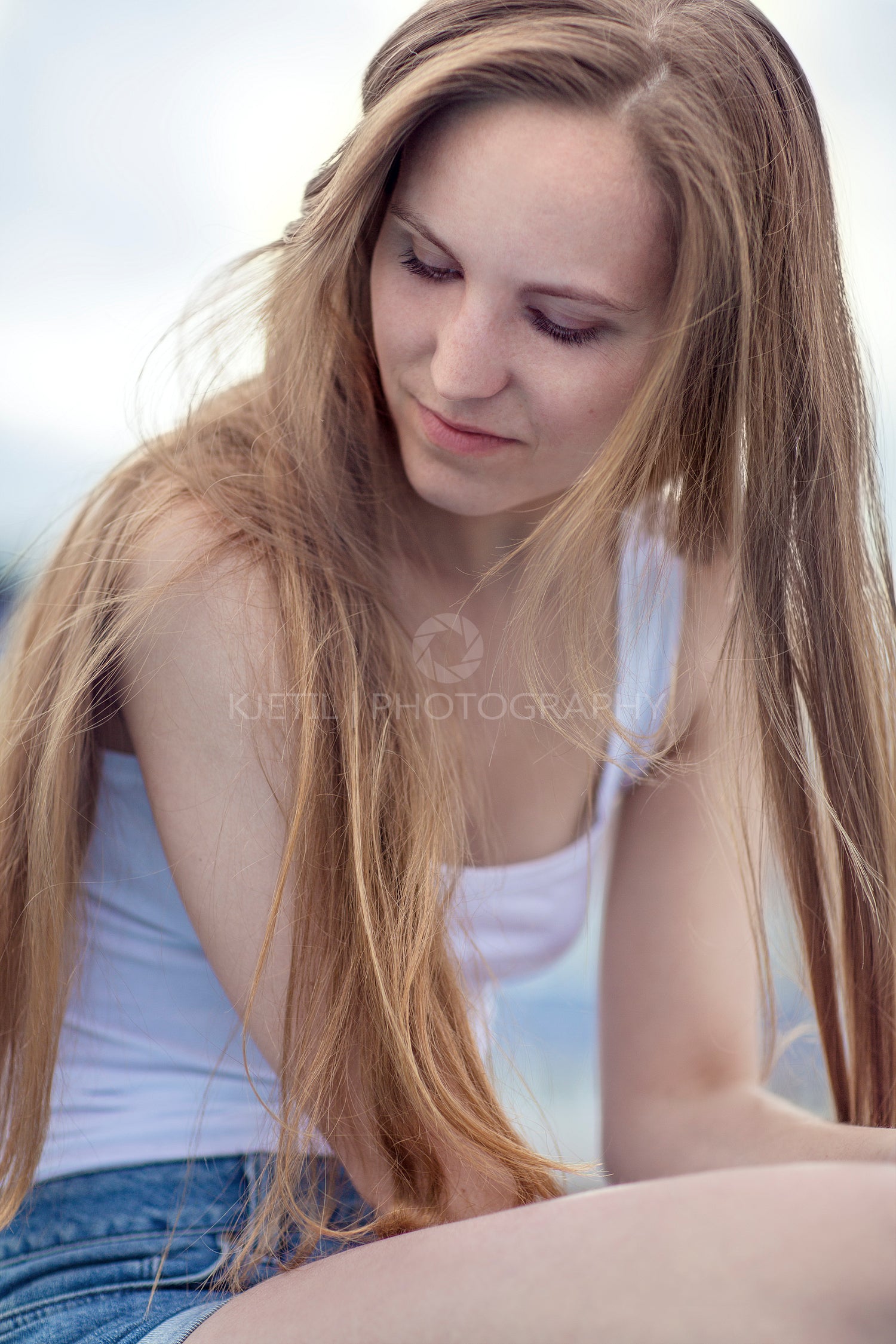 Thinking young model woman sitting outdoor