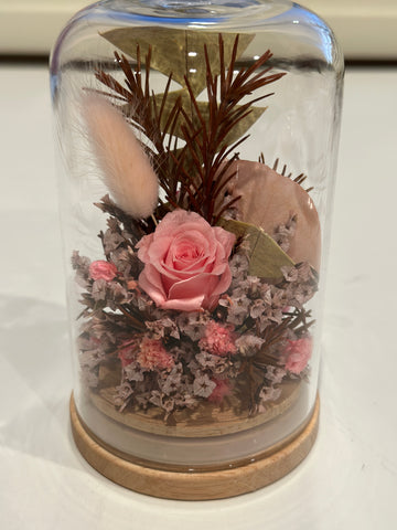 Dried flower dome containing pink florals