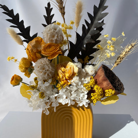 Yellow dried flower arrangement in vase