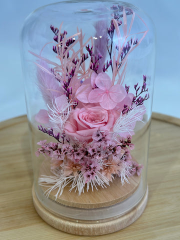 Dome containing pink dried flowers