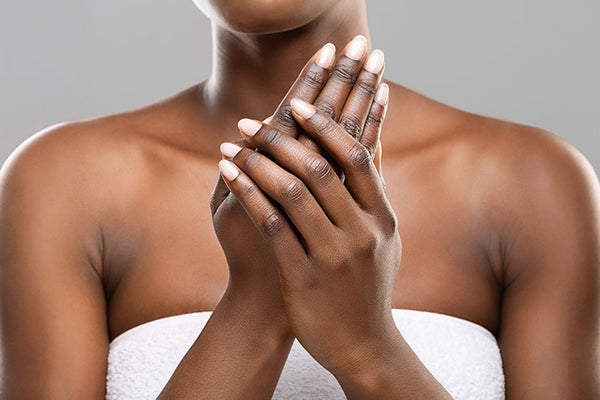 black woman holding her hand while she wear towel